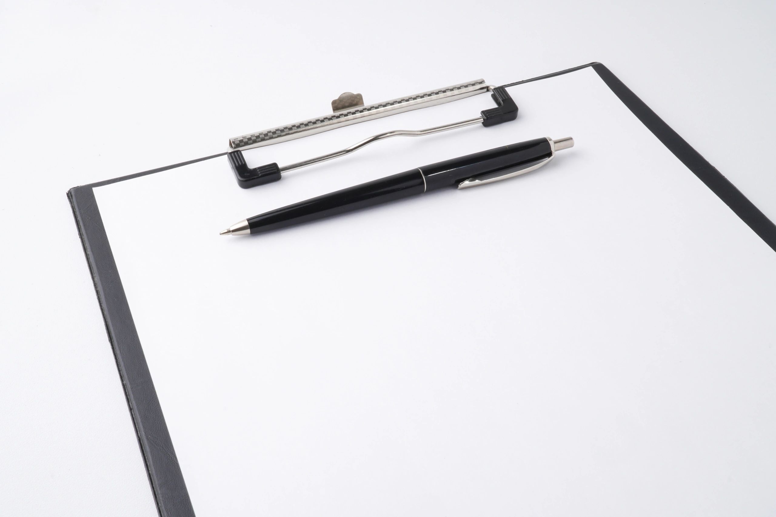 Clipboard and pen representing rental application paperwork